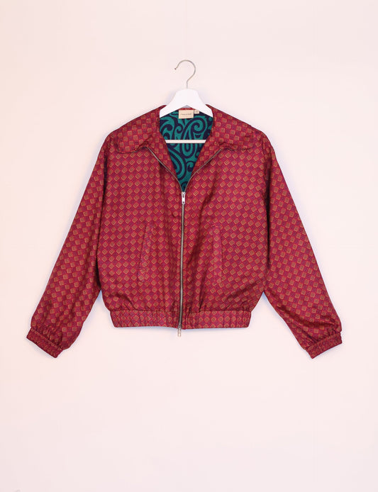 Stylish BOMBER JACKET, an upcycled clothing masterpiece with a cute cropped shape, elasticated details, and detachable metallic zipper. Contrast sari print lining adds a unique touch. Explore sustainable and eco-friendly fashion.