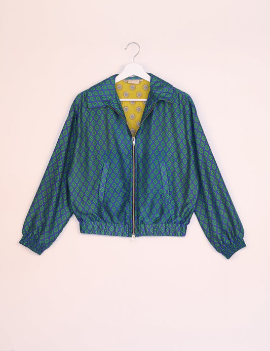 Stylish BOMBER JACKET, an upcycled clothing masterpiece with a cute cropped shape, elasticated details, and detachable metallic zipper. Contrast sari print lining adds a unique touch. Explore sustainable and eco-friendly fashion.