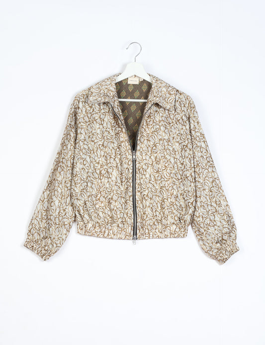 Stylish BOMBER JACKET, an upcycled clothing masterpiece with a cute cropped shape, elasticated details, and detachable metallic zipper. Contrast sari print lining adds a unique touch. Explore sustainable and eco-friendly fashion.