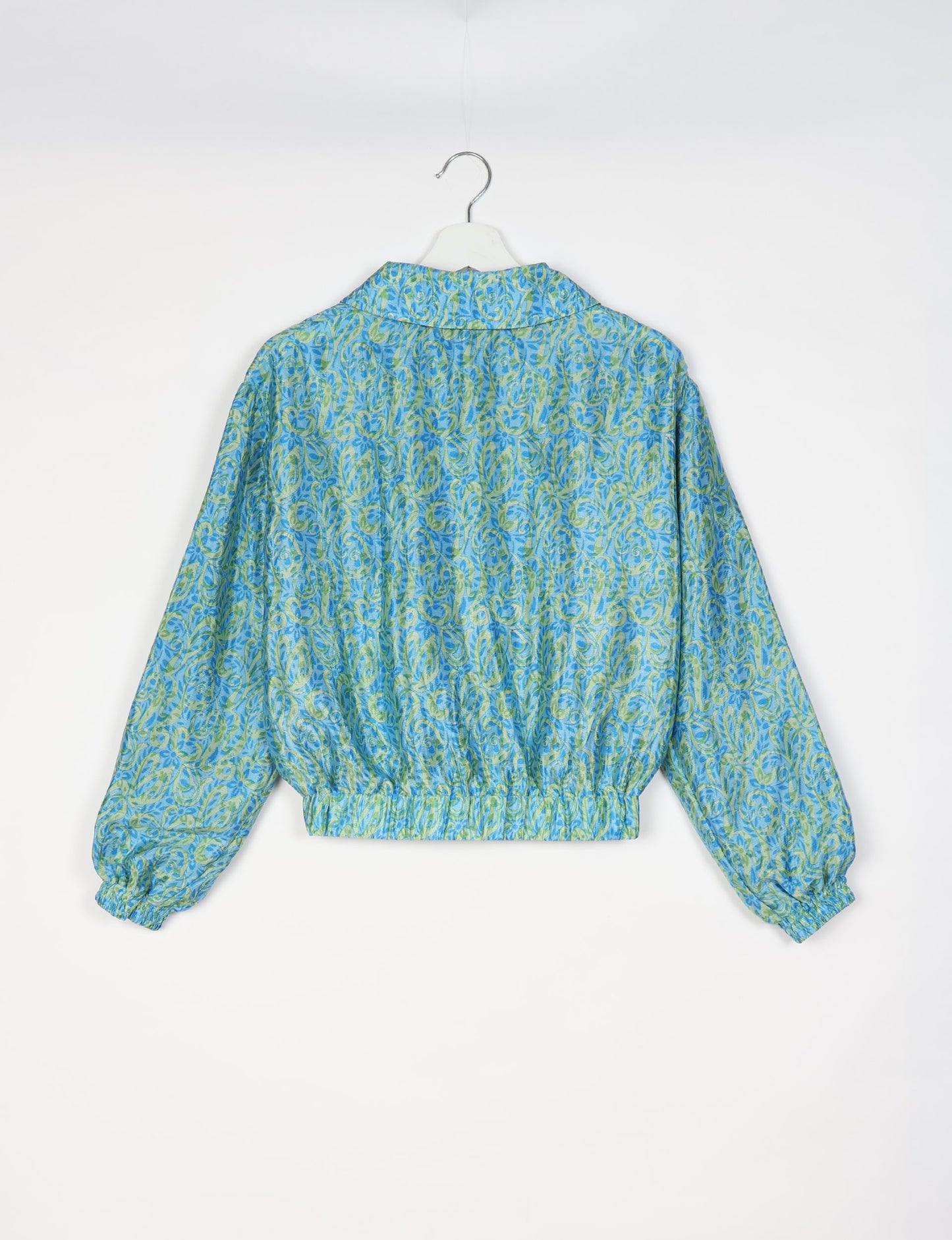Upcycled Bomber Jacket made from recycled sari materials, featuring a cute cropped shape, elasticated hem and cuffs, and contrast sari print lining. Sustainable apparel promoting eco-friendly fashion and ethical clothing.