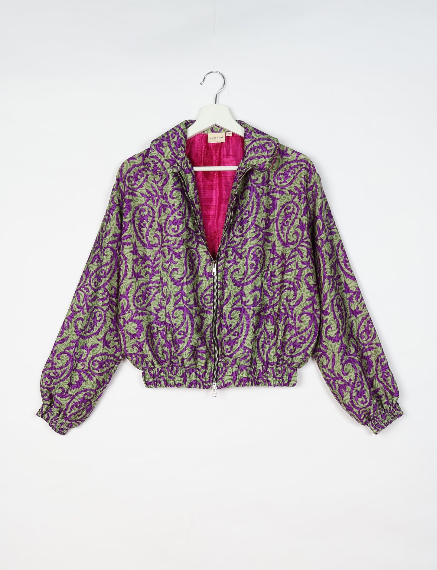 Upcycled Bomber Jacket made from recycled sari materials, featuring a cute cropped shape, elasticated hem and cuffs, and contrast sari print lining. Sustainable apparel promoting eco-friendly fashion and ethical clothing.