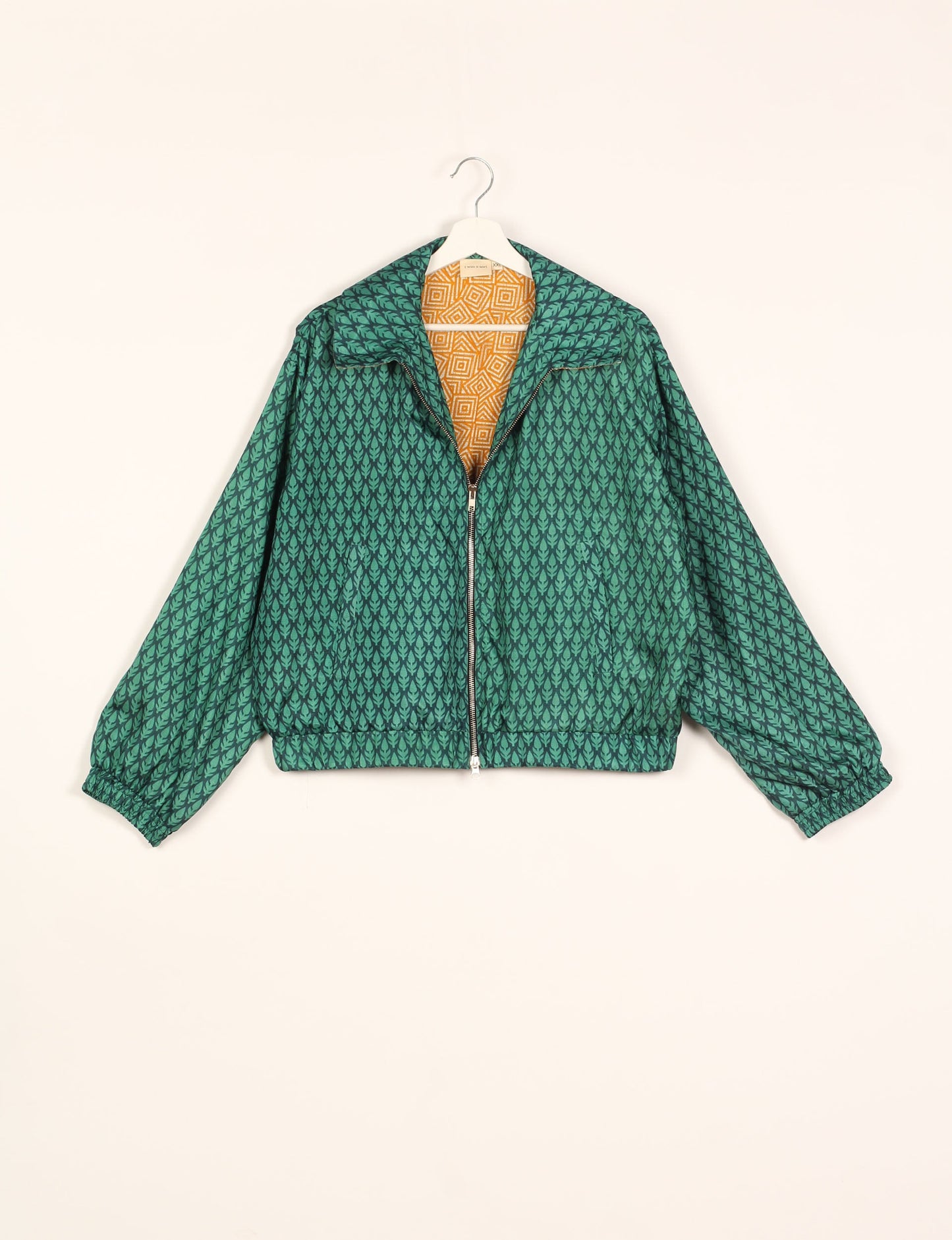 Stylish BOMBER JACKET, an upcycled clothing masterpiece with a cute cropped shape, elasticated details, and detachable metallic zipper. Contrast sari print lining adds a unique touch. Explore sustainable and eco-friendly fashion.