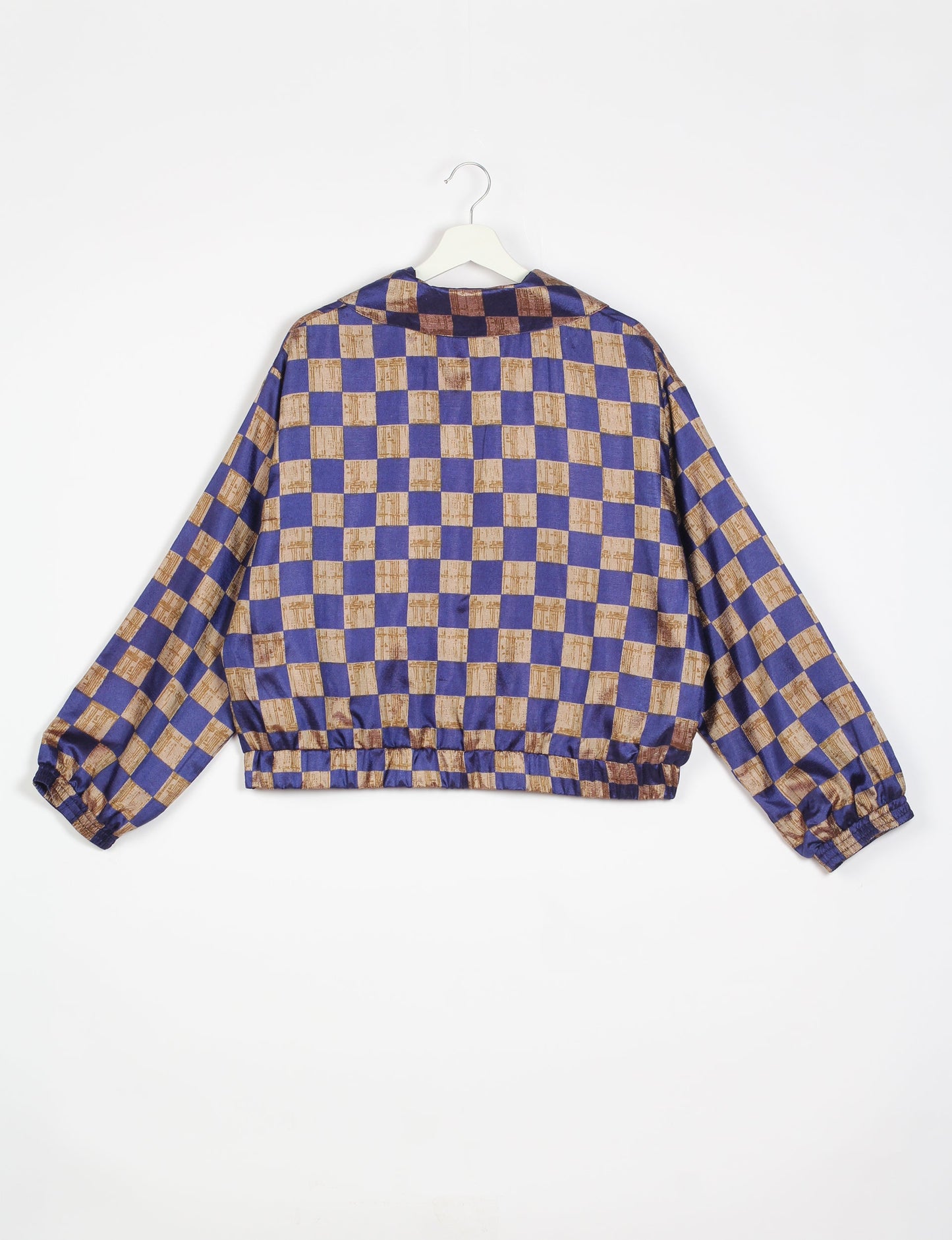 Stylish BOMBER JACKET, an upcycled clothing masterpiece with a cute cropped shape, elasticated details, and detachable metallic zipper. Contrast sari print lining adds a unique touch. Explore sustainable and eco-friendly fashion.