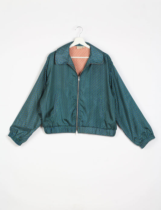 Stylish BOMBER JACKET, an upcycled clothing masterpiece with a cute cropped shape, elasticated details, and detachable metallic zipper. Contrast sari print lining adds a unique touch. Explore sustainable and eco-friendly fashion.