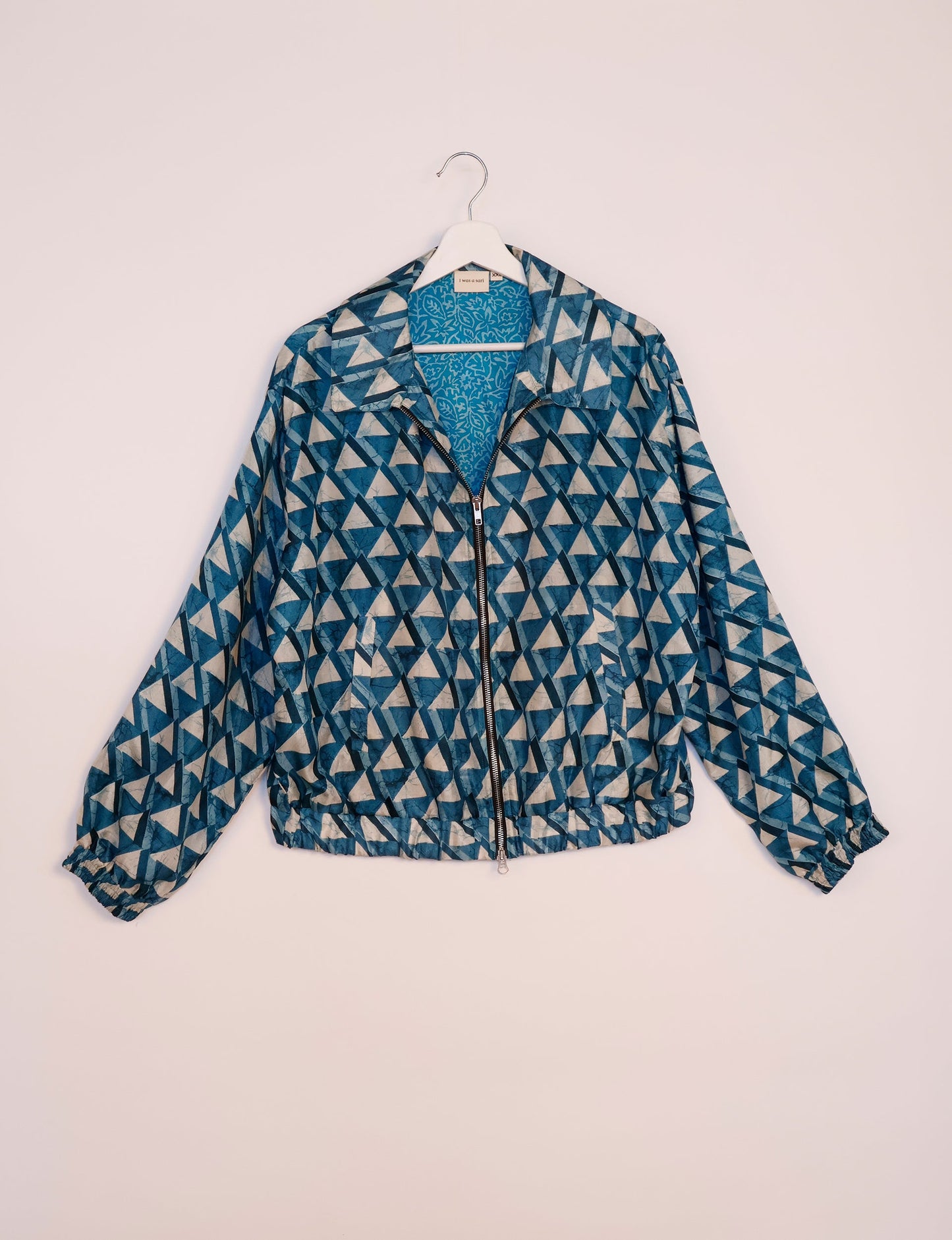 Stylish BOMBER JACKET, an upcycled clothing masterpiece with a cute cropped shape, elasticated details, and detachable metallic zipper. Contrast sari print lining adds a unique touch. Explore sustainable and eco-friendly fashion.