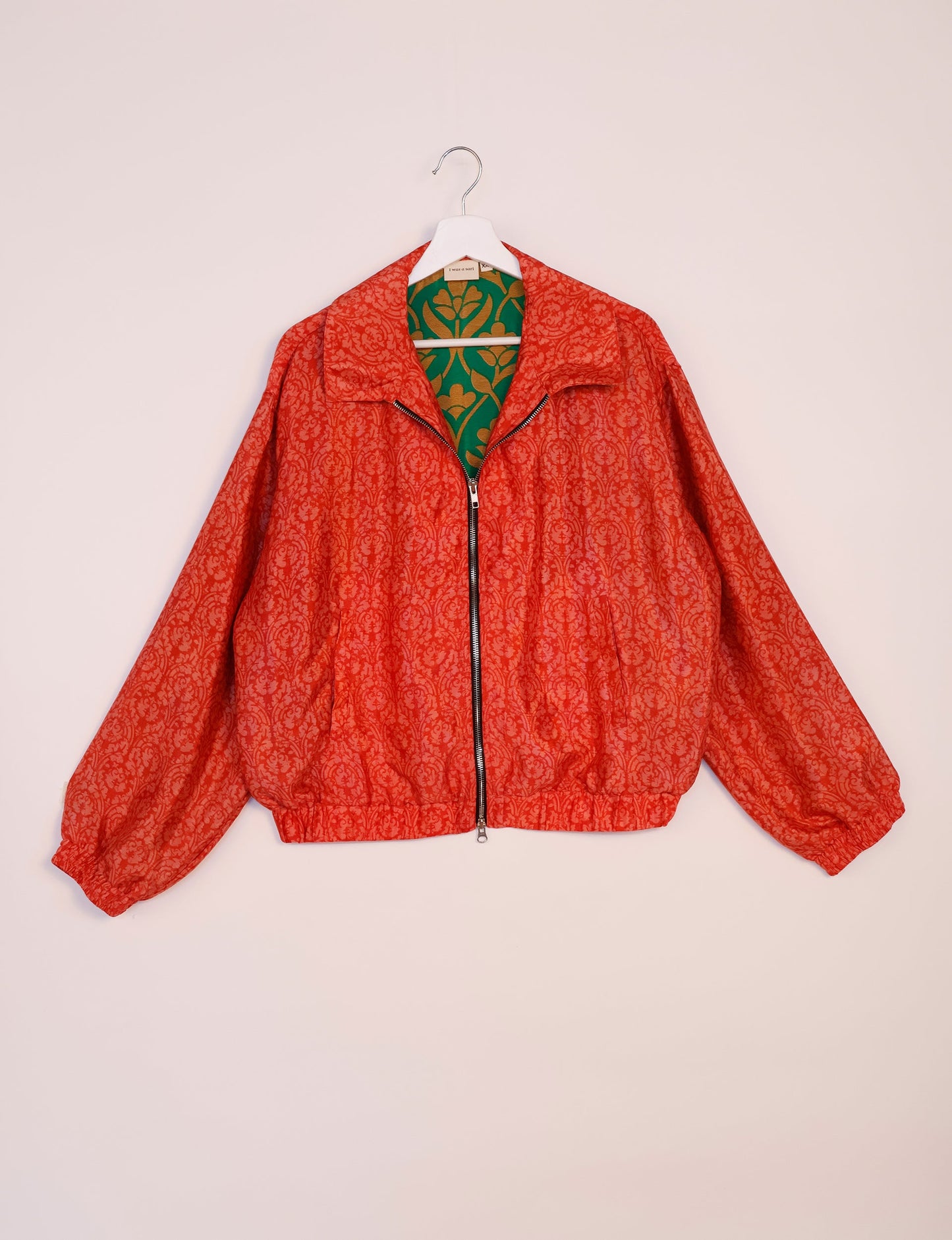 Stylish BOMBER JACKET, an upcycled clothing masterpiece with a cute cropped shape, elasticated details, and detachable metallic zipper. Contrast sari print lining adds a unique touch. Explore sustainable and eco-friendly fashion.