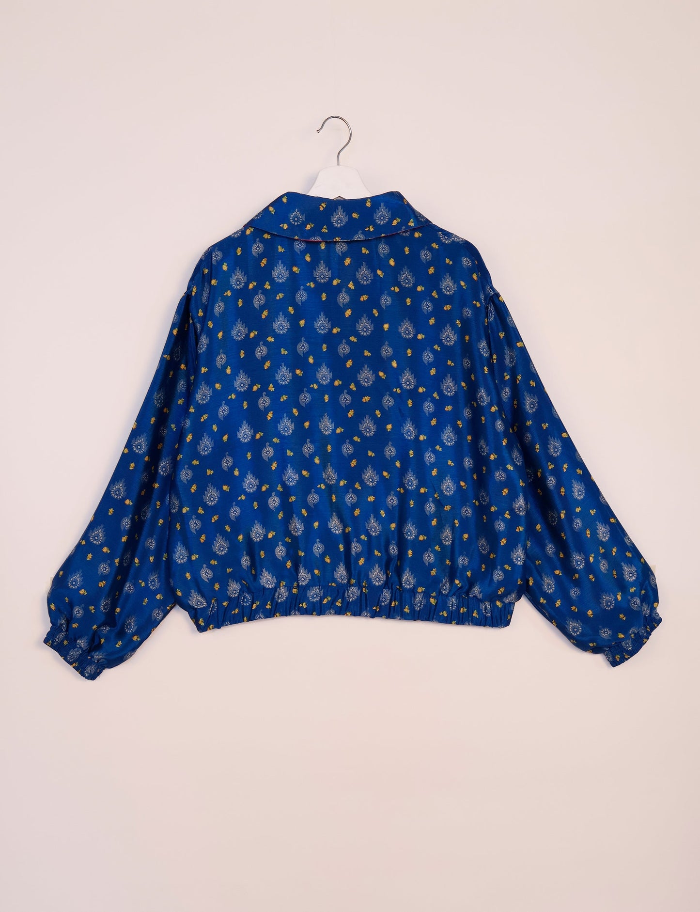 Stylish BOMBER JACKET, an upcycled clothing masterpiece with a cute cropped shape, elasticated details, and detachable metallic zipper. Contrast sari print lining adds a unique touch. Explore sustainable and eco-friendly fashion.