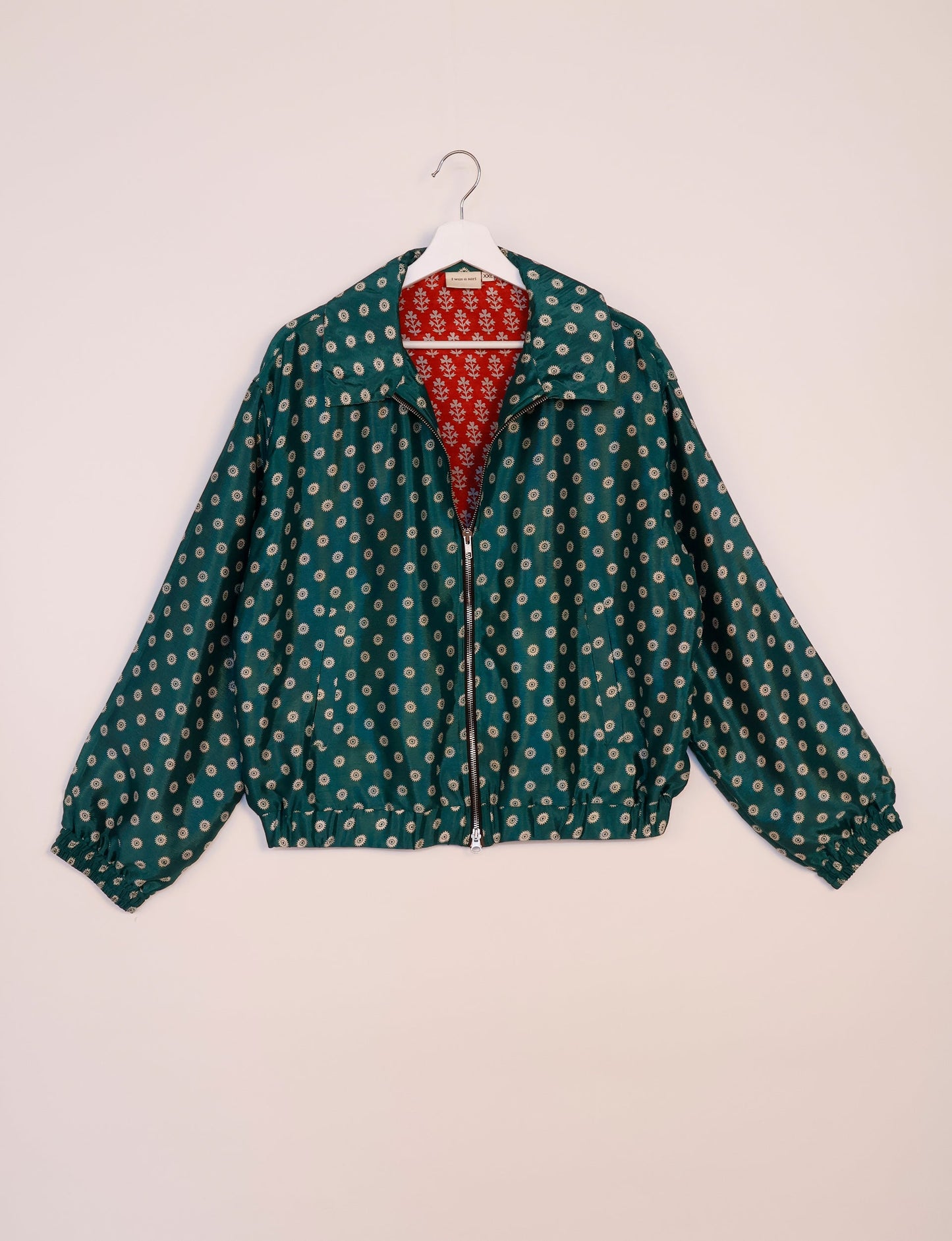 Stylish BOMBER JACKET, an upcycled clothing masterpiece with a cute cropped shape, elasticated details, and detachable metallic zipper. Contrast sari print lining adds a unique touch. Explore sustainable and eco-friendly fashion.