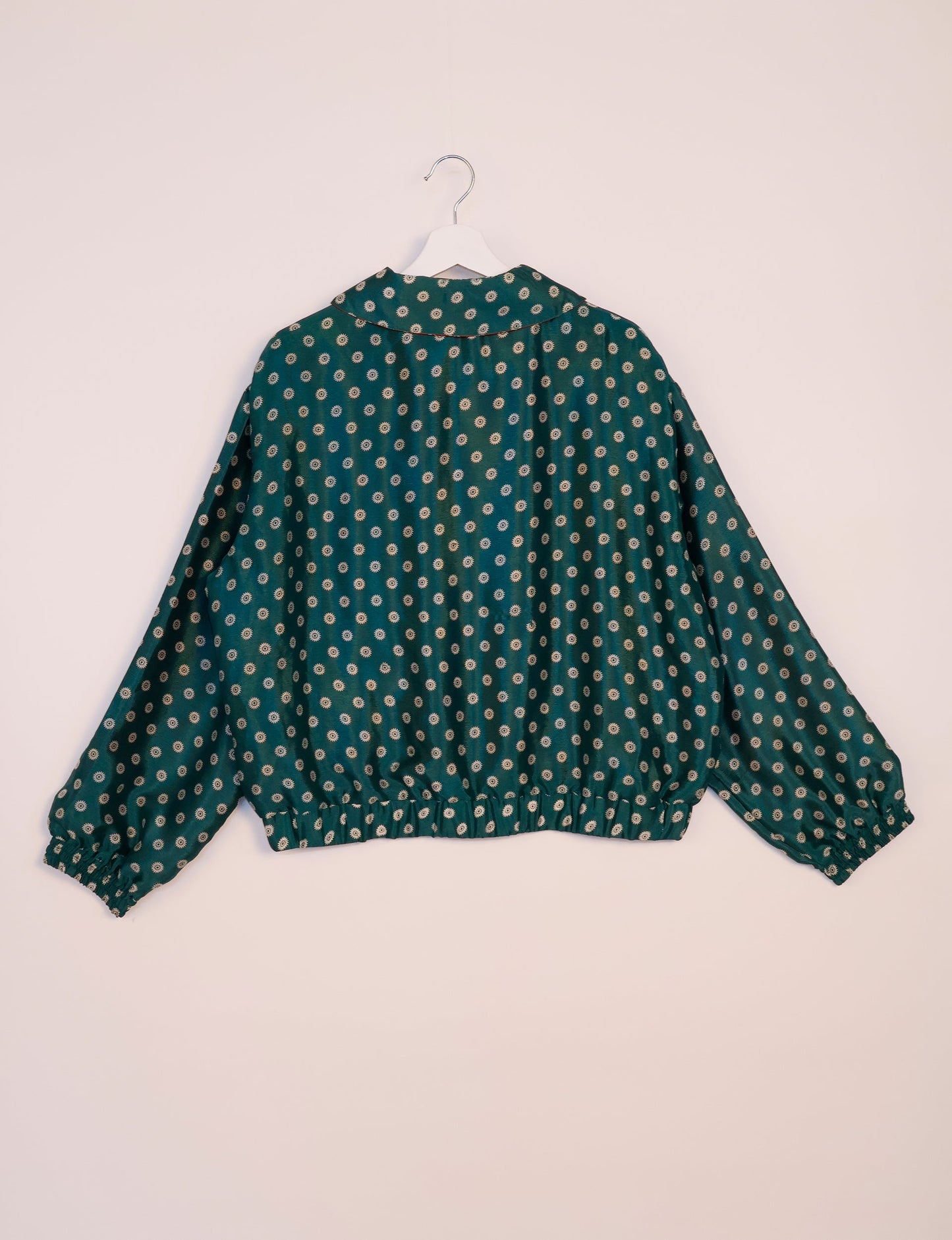 Stylish BOMBER JACKET, an upcycled clothing masterpiece with a cute cropped shape, elasticated details, and detachable metallic zipper. Contrast sari print lining adds a unique touch. Explore sustainable and eco-friendly fashion.