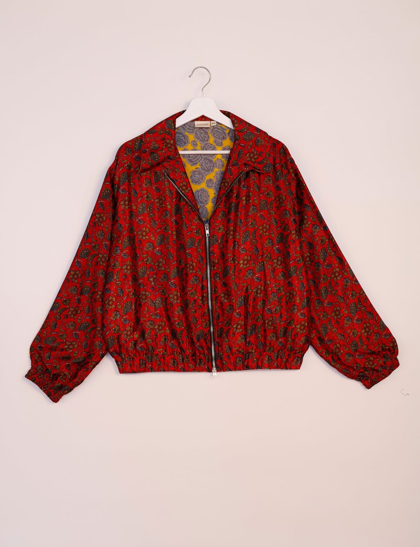 Stylish BOMBER JACKET, an upcycled clothing masterpiece with a cute cropped shape, elasticated details, and detachable metallic zipper. Contrast sari print lining adds a unique touch. Explore sustainable and eco-friendly fashion.