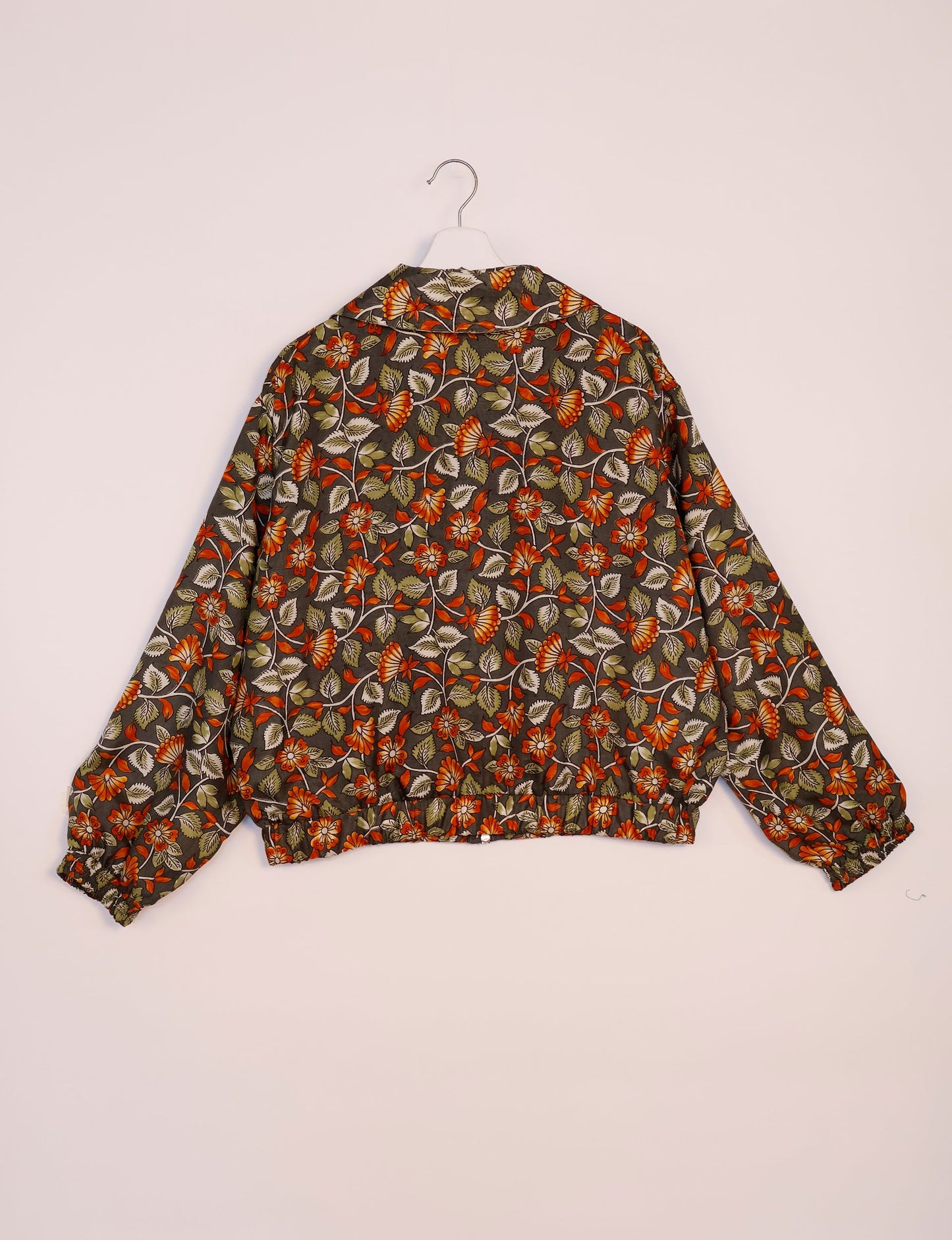 Stylish BOMBER JACKET, an upcycled clothing masterpiece with a cute cropped shape, elasticated details, and detachable metallic zipper. Contrast sari print lining adds a unique touch. Explore sustainable and eco-friendly fashion.