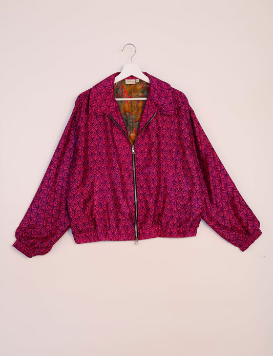 Stylish BOMBER JACKET, an upcycled clothing masterpiece with a cute cropped shape, elasticated details, and detachable metallic zipper. Contrast sari print lining adds a unique touch. Explore sustainable and eco-friendly fashion.