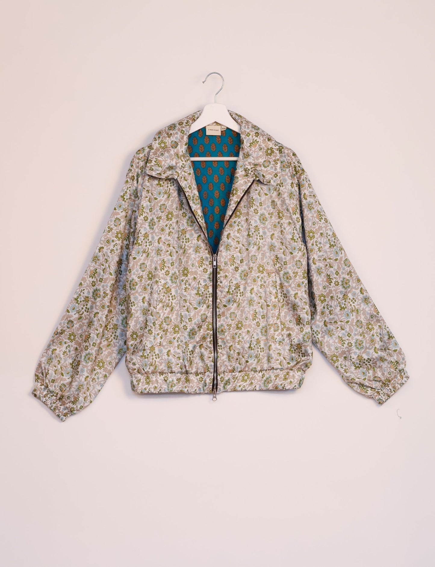 Stylish BOMBER JACKET, an upcycled clothing masterpiece with a cute cropped shape, elasticated details, and detachable metallic zipper. Contrast sari print lining adds a unique touch. Explore sustainable and eco-friendly fashion.