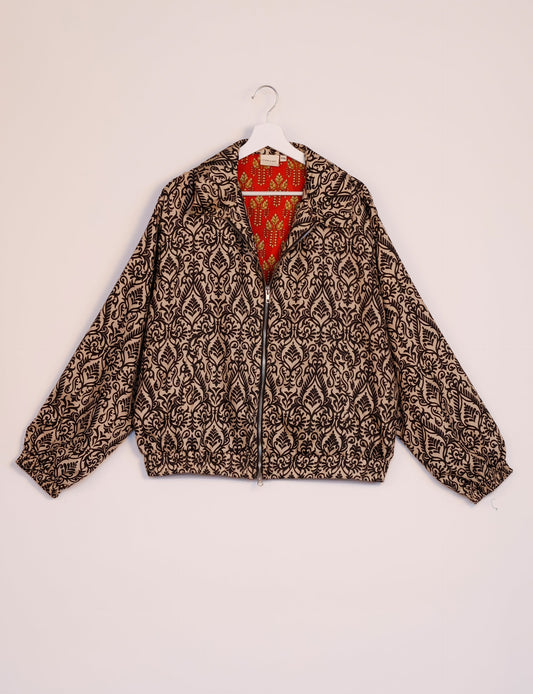 Stylish BOMBER JACKET, an upcycled clothing masterpiece with a cute cropped shape, elasticated details, and detachable metallic zipper. Contrast sari print lining adds a unique touch. Explore sustainable and eco-friendly fashion.