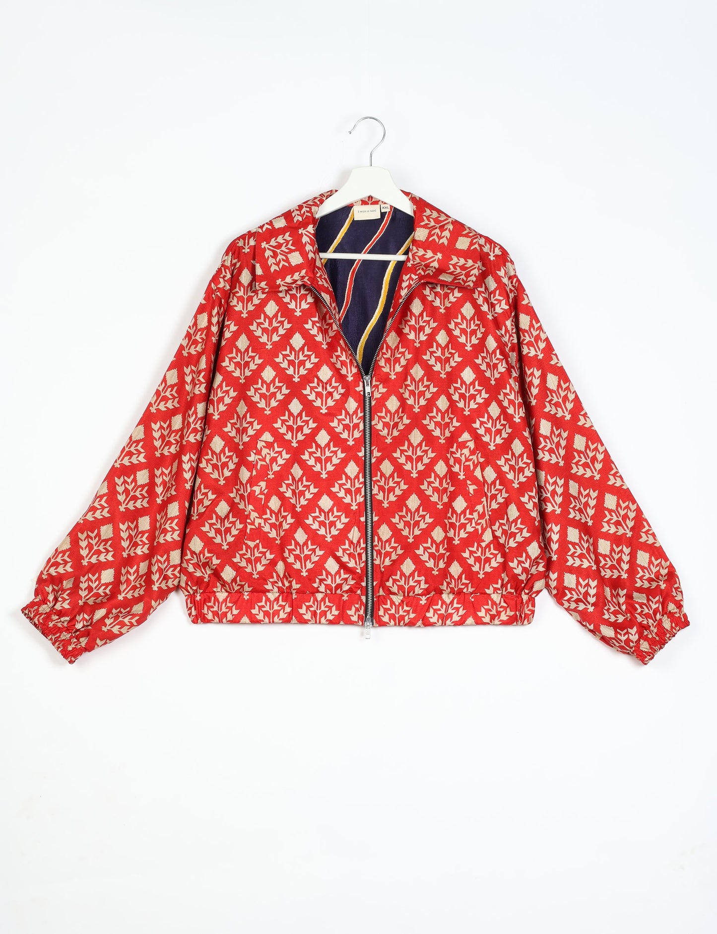 Stylish BOMBER JACKET, an upcycled clothing masterpiece with a cute cropped shape, elasticated details, and detachable metallic zipper. Contrast sari print lining adds a unique touch. Explore sustainable and eco-friendly fashion.