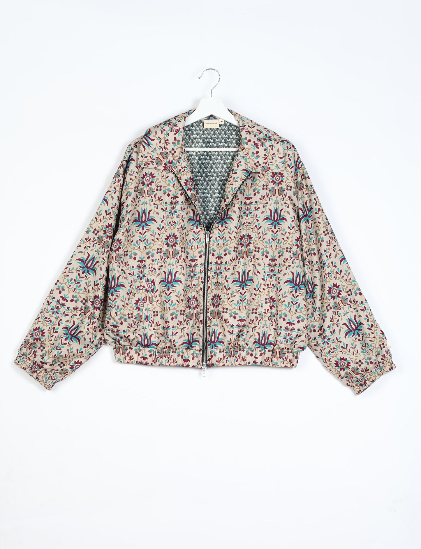 Stylish BOMBER JACKET, an upcycled clothing masterpiece with a cute cropped shape, elasticated details, and detachable metallic zipper. Contrast sari print lining adds a unique touch. Explore sustainable and eco-friendly fashion.