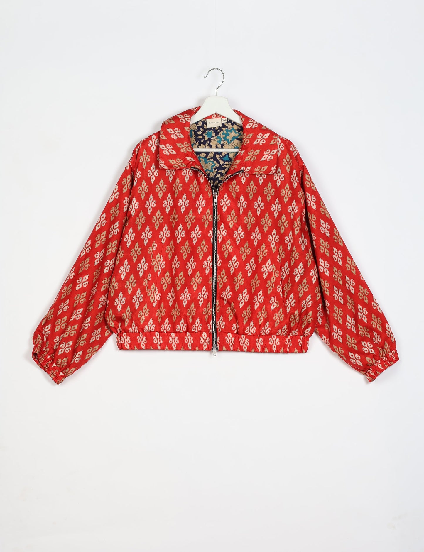 Stylish BOMBER JACKET, an upcycled clothing masterpiece with a cute cropped shape, elasticated details, and detachable metallic zipper. Contrast sari print lining adds a unique touch. Explore sustainable and eco-friendly fashion.