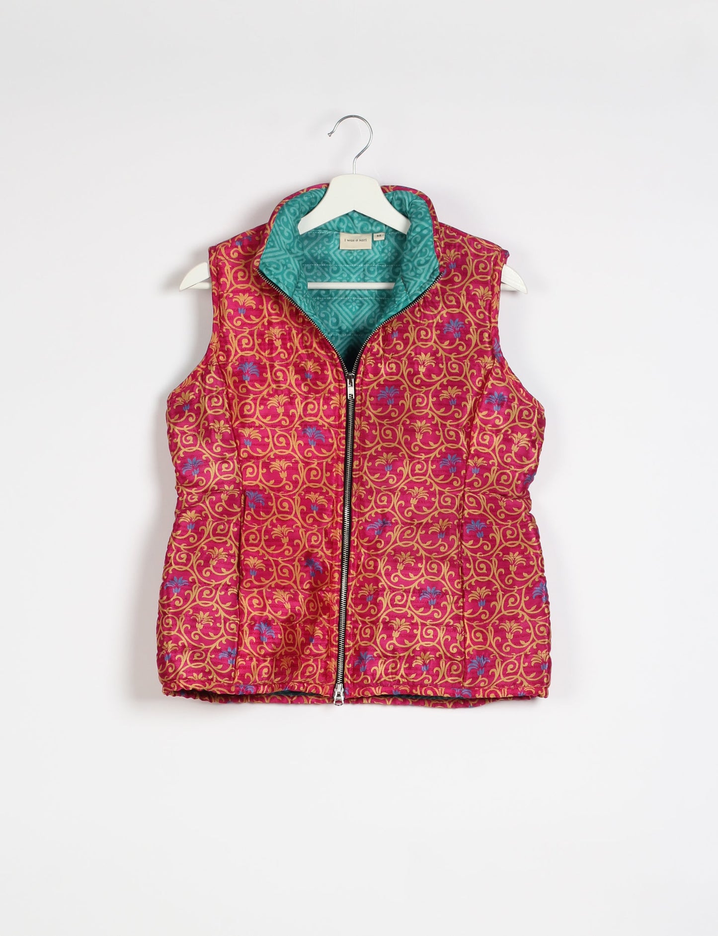 Elevate your style with our QUILTED GILET, crafted from upcycled tropical saris. This sleeveless jacket, with its quilted warmth, is perfect for layering over tees or sweaters. Choose ethical, green fashion and experience the comfort of sustainable living with a touch of home.