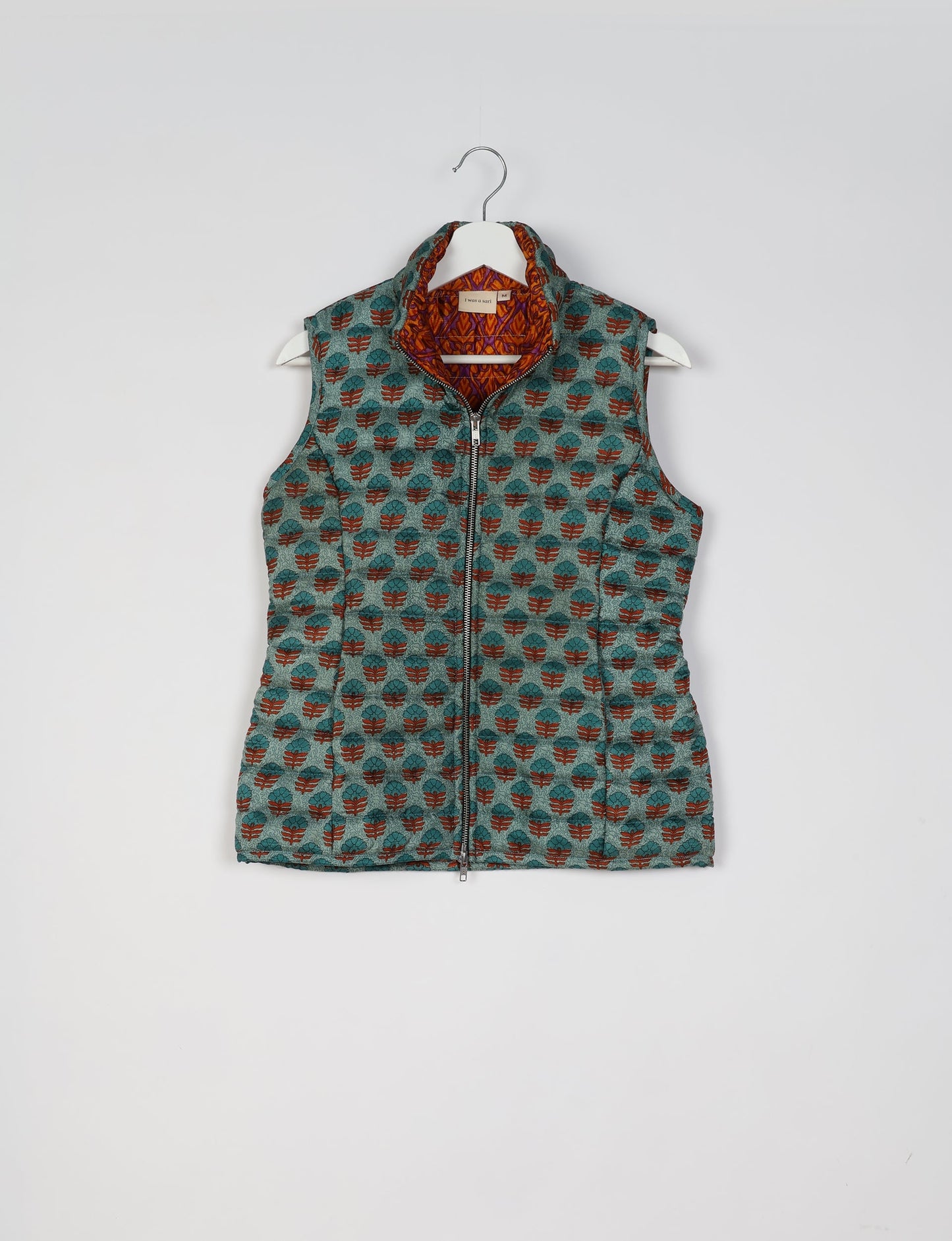 Elevate your style with our QUILTED GILET, crafted from upcycled tropical saris. This sleeveless jacket, with its quilted warmth, is perfect for layering over tees or sweaters. Choose ethical, green fashion and experience the comfort of sustainable living with a touch of home.