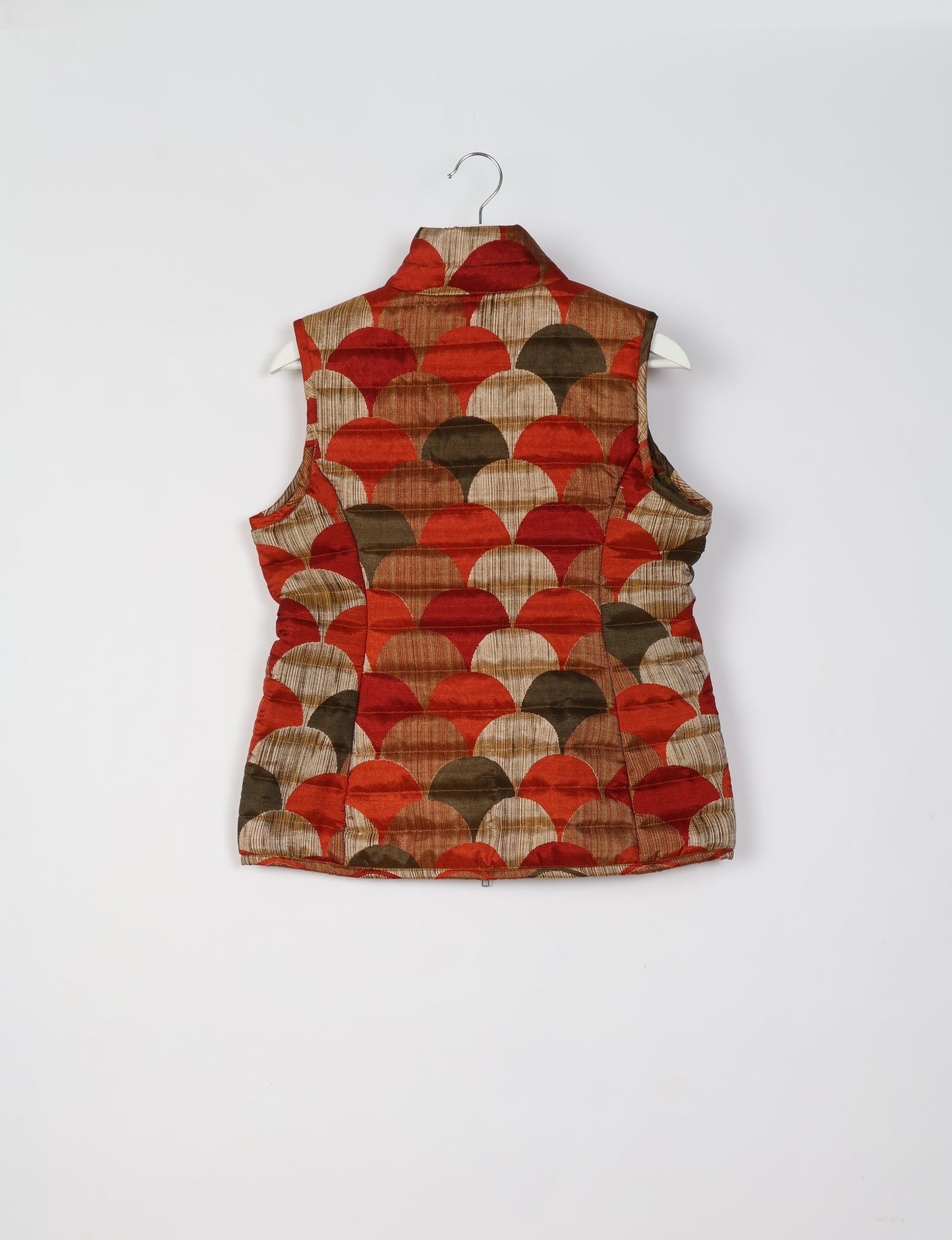 Elevate your style with our QUILTED GILET, crafted from upcycled tropical saris. This sleeveless jacket, with its quilted warmth, is perfect for layering over tees or sweaters. Choose ethical, green fashion and experience the comfort of sustainable living with a touch of home.