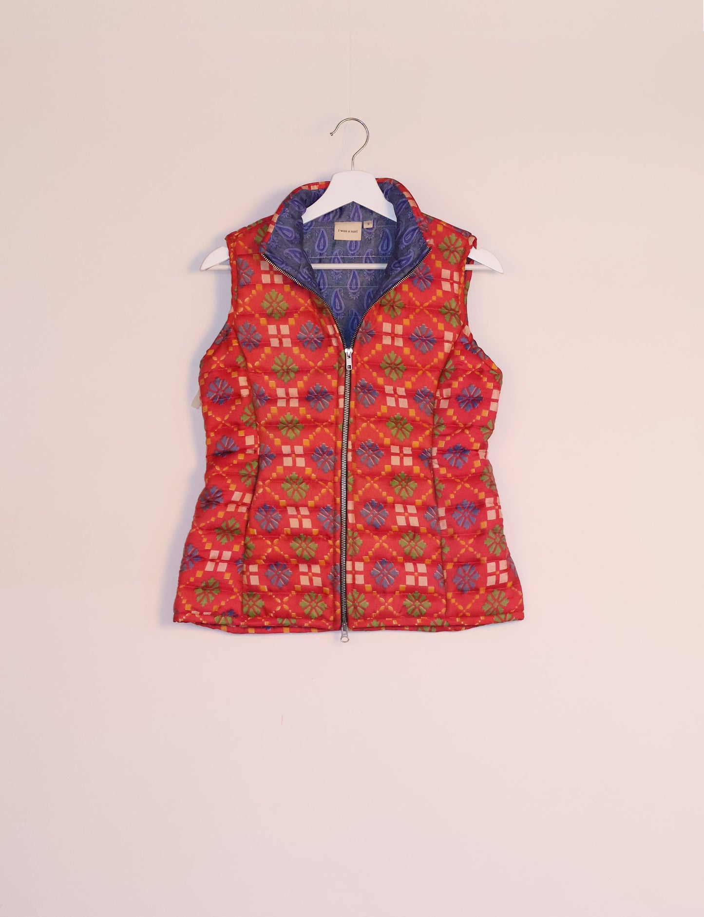 Elevate your style with our QUILTED GILET, crafted from upcycled tropical saris. This sleeveless jacket, with its quilted warmth, is perfect for layering over tees or sweaters. Choose ethical, green fashion and experience the comfort of sustainable living with a touch of home.