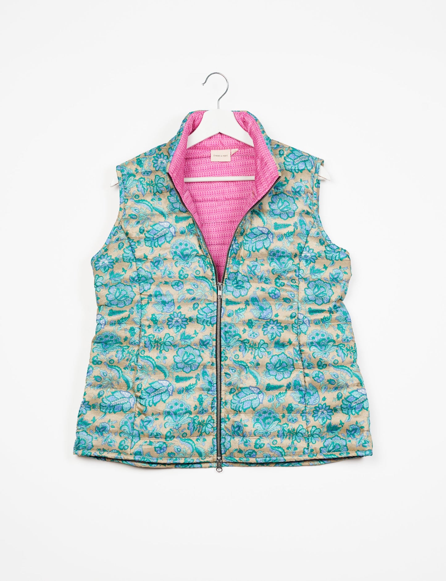 Elevate your style with our QUILTED GILET, crafted from upcycled tropical saris. This sleeveless jacket, with its quilted warmth, is perfect for layering over tees or sweaters. Choose ethical, green fashion and experience the comfort of sustainable living with a touch of home.