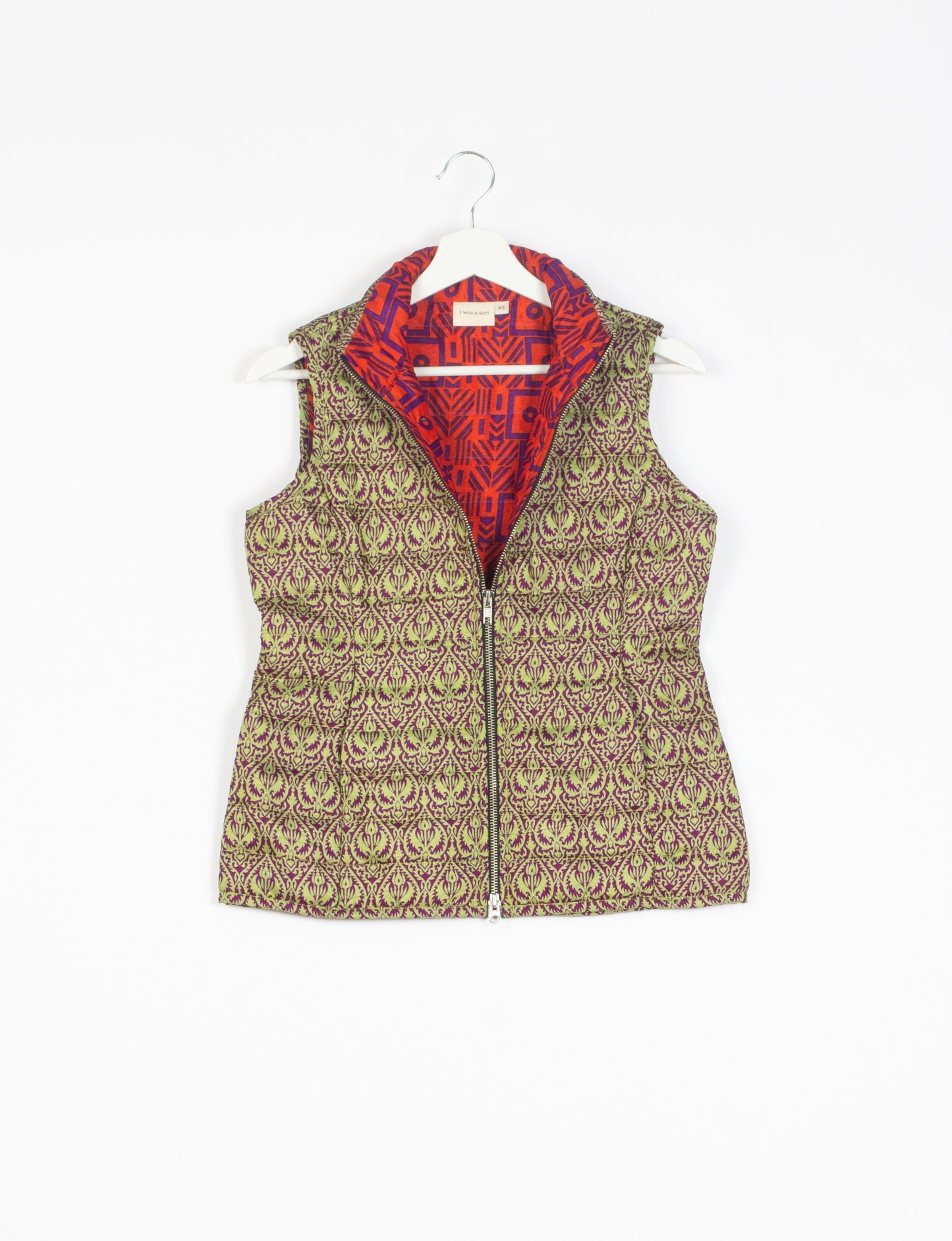 Elevate your style with our QUILTED GILET, crafted from upcycled tropical saris. This sleeveless jacket, with its quilted warmth, is perfect for layering over tees or sweaters. Choose ethical, green fashion and experience the comfort of sustainable living with a touch of home.