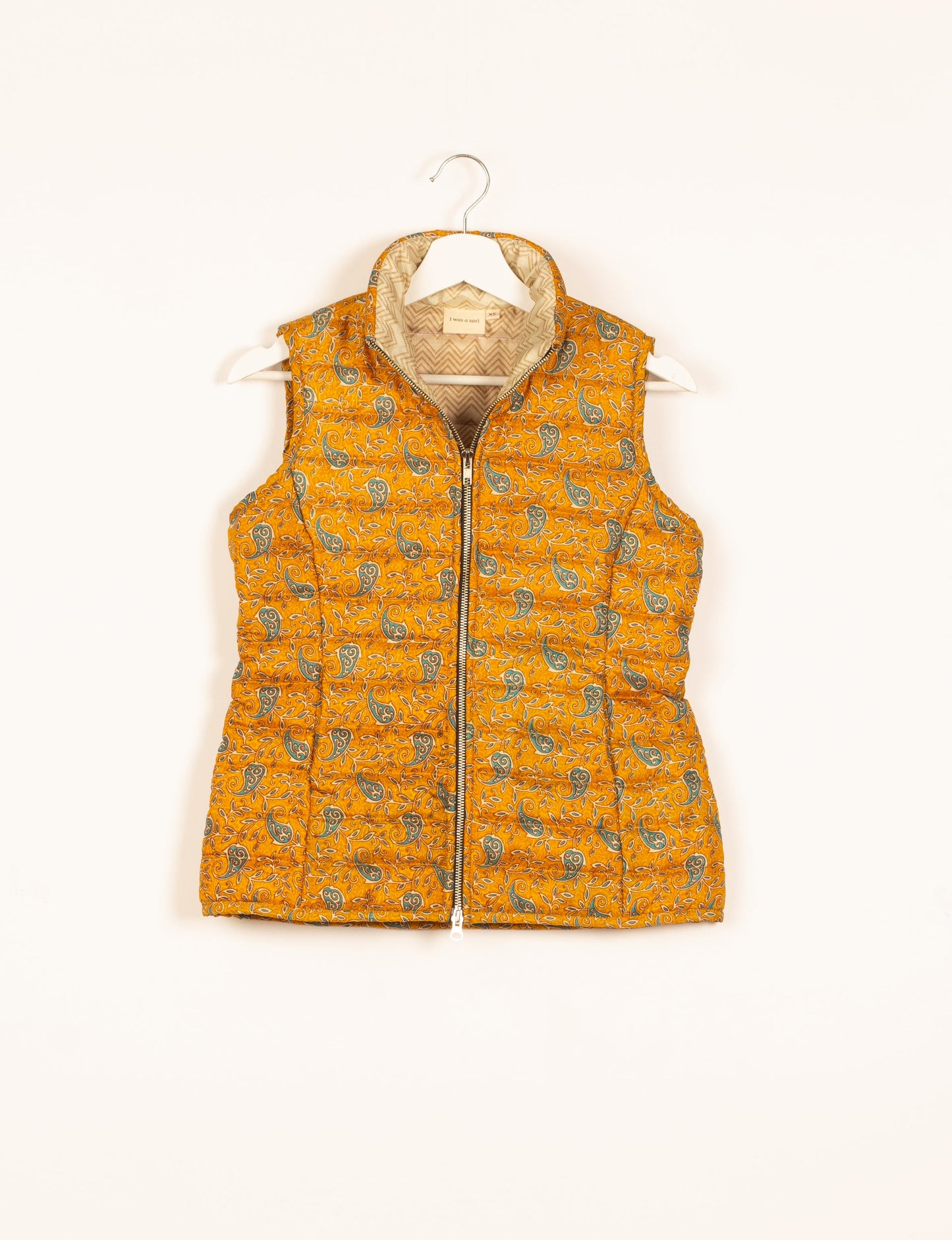 Elevate your style with our QUILTED GILET, crafted from upcycled tropical saris. This sleeveless jacket, with its quilted warmth, is perfect for layering over tees or sweaters. Choose ethical, green fashion and experience the comfort of sustainable living with a touch of home.