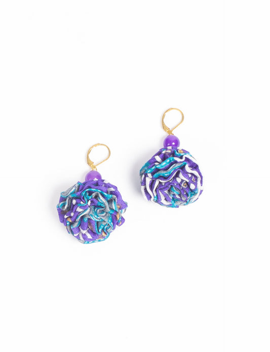 Elevate your style with our Ruffle Earrings, adorned with unique ruffle ball florets crafted from upcycled Indian saris using the traditional Aari embroidery technique. These sustainable earrings feature two glass beads and nickel-free, hypoallergenic metal hooks. Embrace ethical and green fashion with these statement pieces.