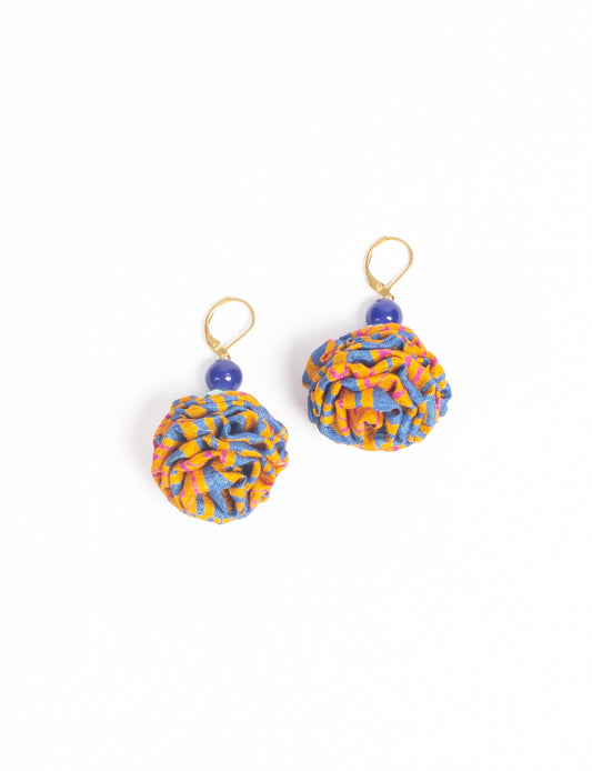 Elevate your style with our Ruffle Earrings, adorned with unique ruffle ball florets crafted from upcycled Indian saris using the traditional Aari embroidery technique. These sustainable earrings feature two glass beads and nickel-free, hypoallergenic metal hooks. Embrace ethical and green fashion with these statement pieces.