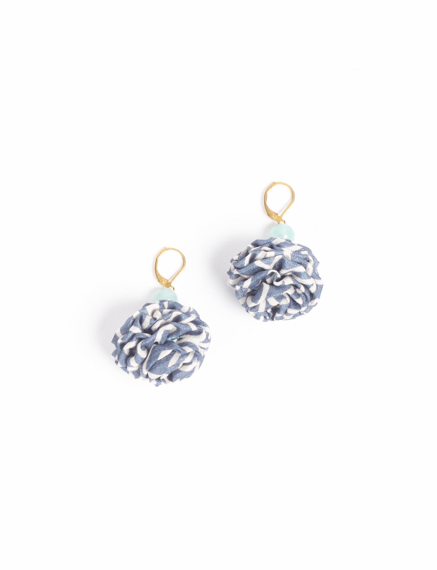 Elevate your style with our Ruffle Earrings, adorned with unique ruffle ball florets crafted from upcycled Indian saris using the traditional Aari embroidery technique. These sustainable earrings feature two glass beads and nickel-free, hypoallergenic metal hooks. Embrace ethical and green fashion with these statement pieces.