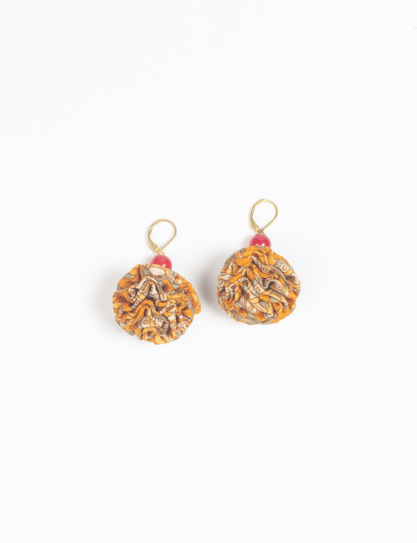 Elevate your style with our Ruffle Earrings, adorned with unique ruffle ball florets crafted from upcycled Indian saris using the traditional Aari embroidery technique. These sustainable earrings feature two glass beads and nickel-free, hypoallergenic metal hooks. Embrace ethical and green fashion with these statement pieces.