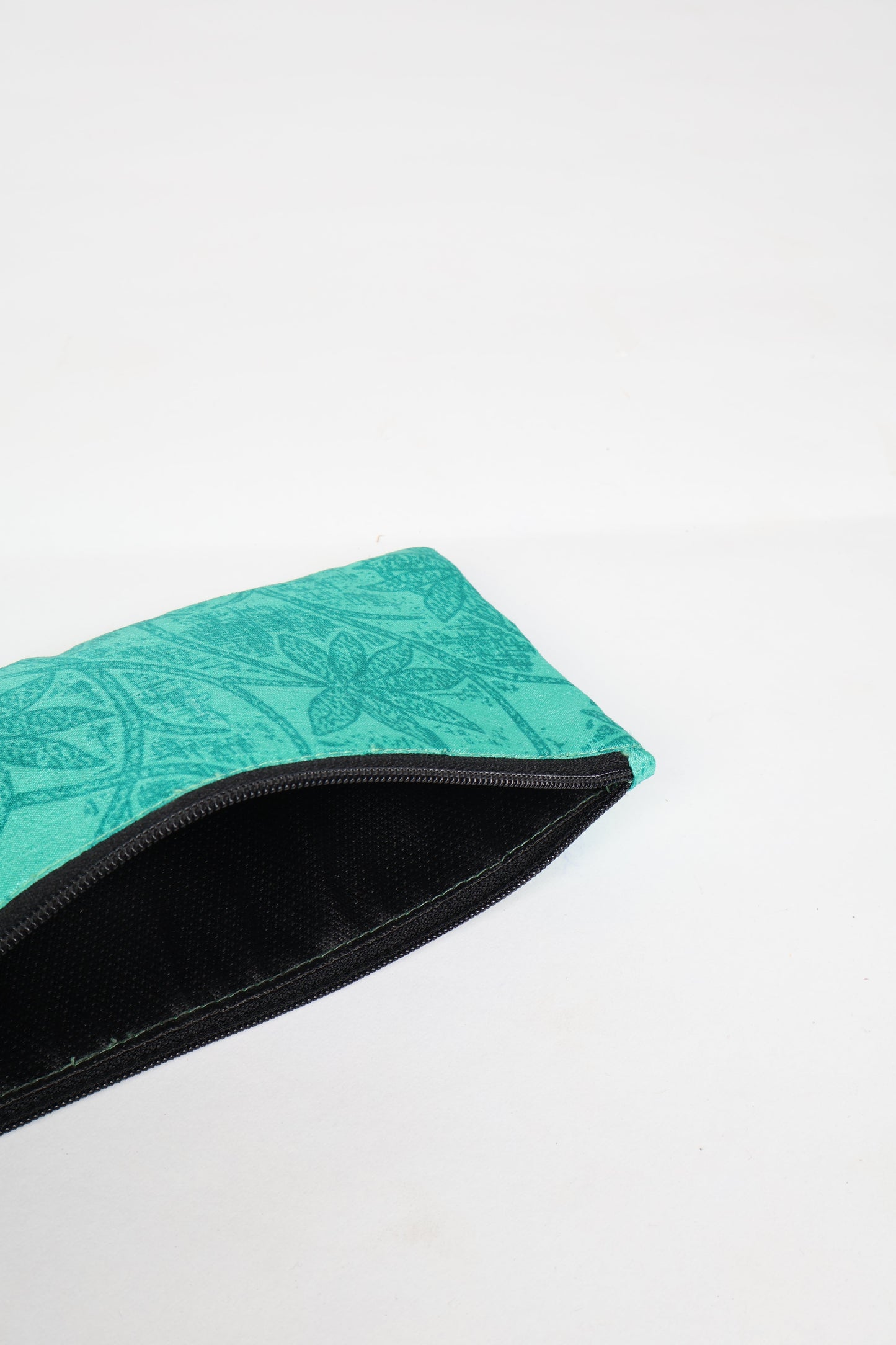 Eco-conscious quilted pencil pouch with waterproof lining made from upcycled garments, reflecting the values of circular fashion, carbon neutral fashion, and repurposed clothing. A perfect example of green fashion and sustainable women's clothing.