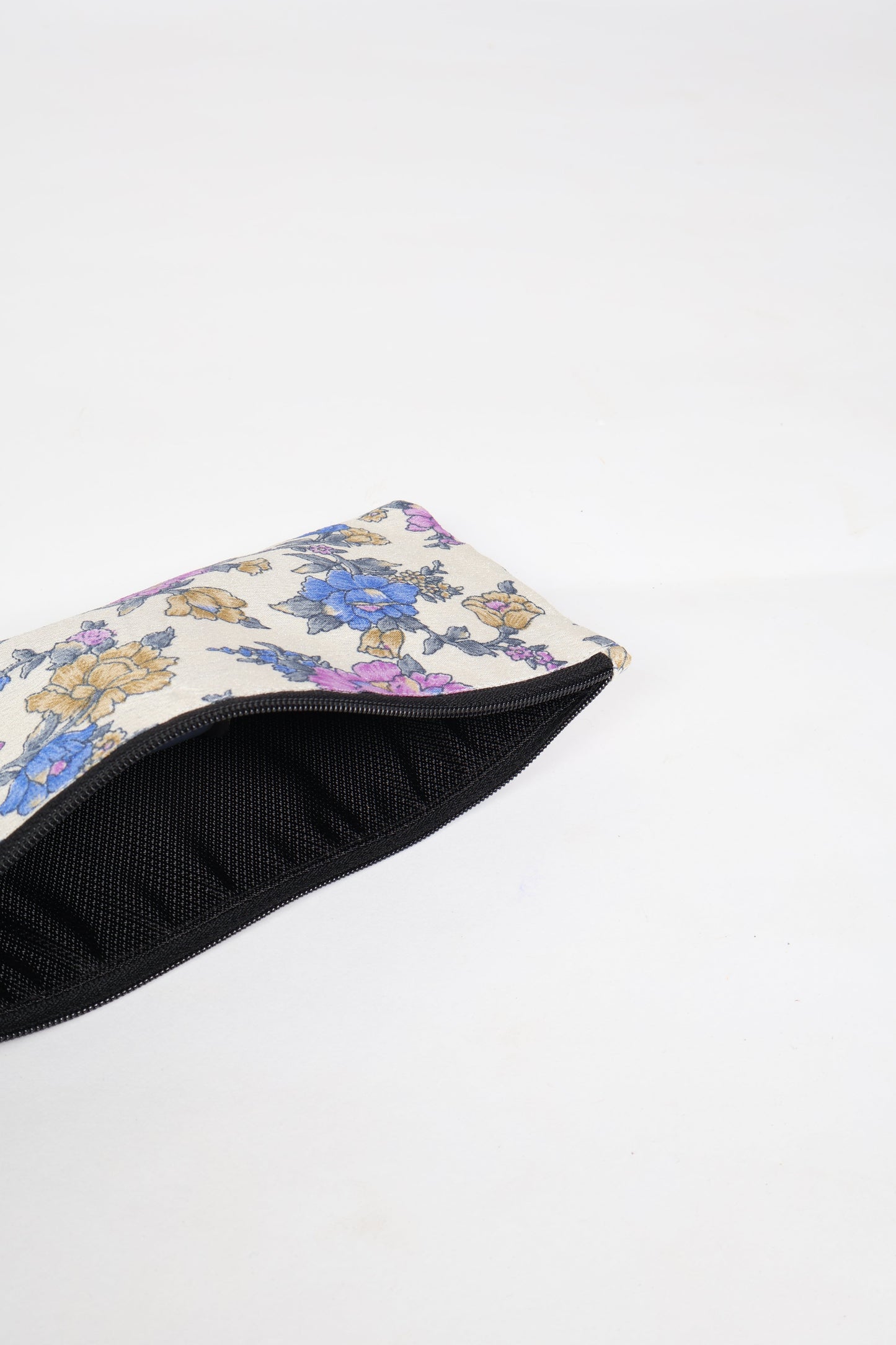 Eco-conscious quilted pencil pouch with waterproof lining made from upcycled garments, reflecting the values of circular fashion, carbon neutral fashion, and repurposed clothing. A perfect example of green fashion and sustainable women's clothing.