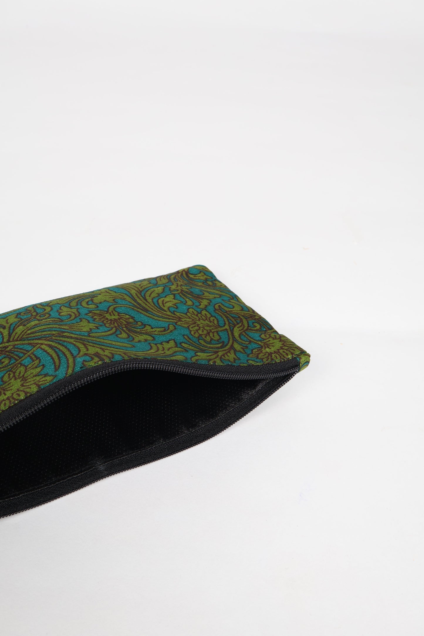 Eco-conscious quilted pencil pouch with waterproof lining made from upcycled garments, reflecting the values of circular fashion, carbon neutral fashion, and repurposed clothing. A perfect example of green fashion and sustainable women's clothing.