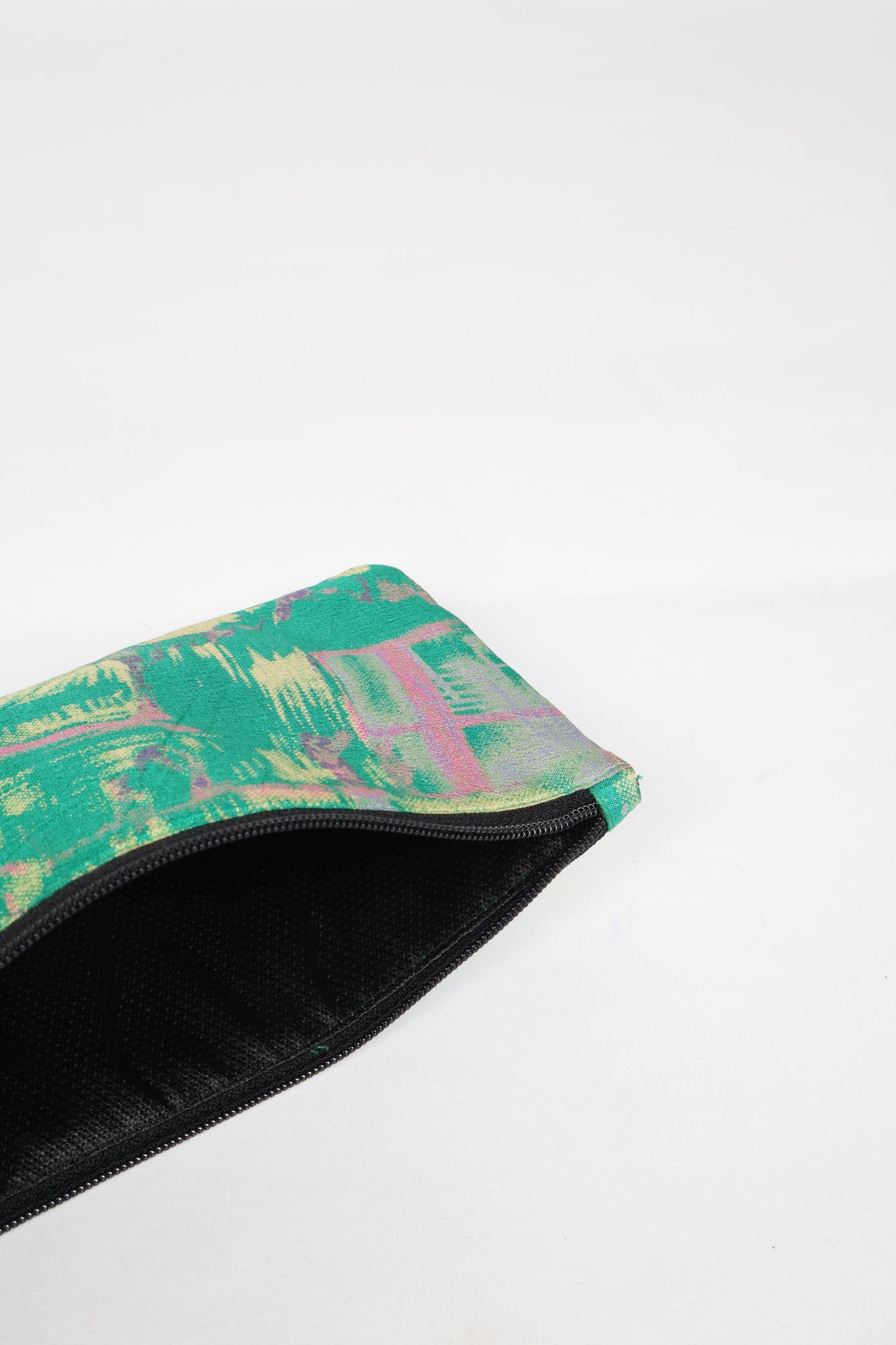 Eco-conscious quilted pencil pouch with waterproof lining made from upcycled garments, reflecting the values of circular fashion, carbon neutral fashion, and repurposed clothing. A perfect example of green fashion and sustainable women's clothing.
