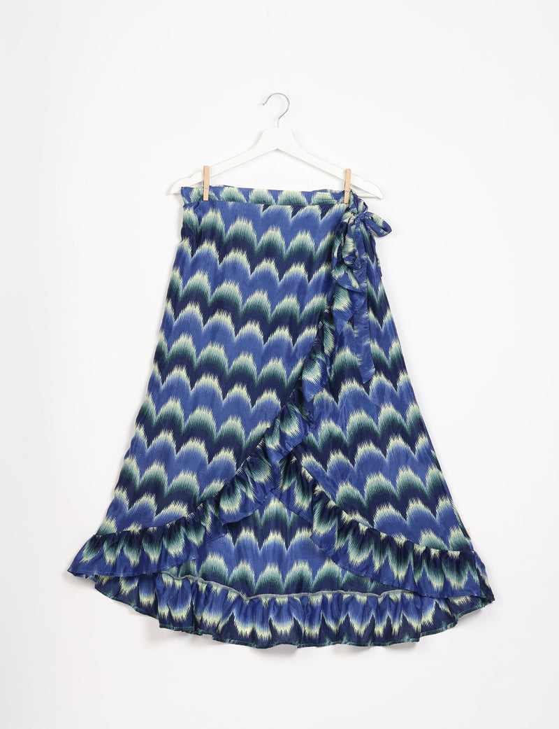 Blue ikat patterned frill skirt with wrap tie detail, hanging on white hanger against white background