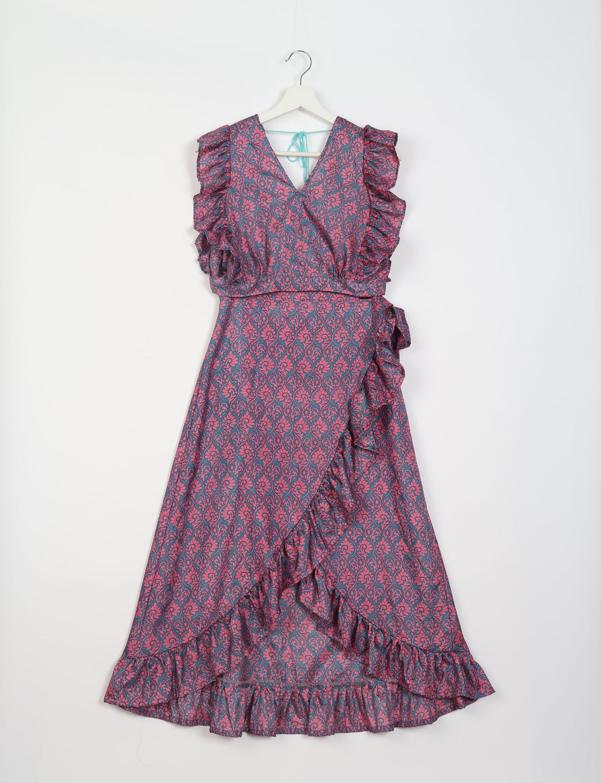 Pink and blue floral frill skirt set with V-neck, ruffled sleeves, and wrap-style front hanging on white hanger