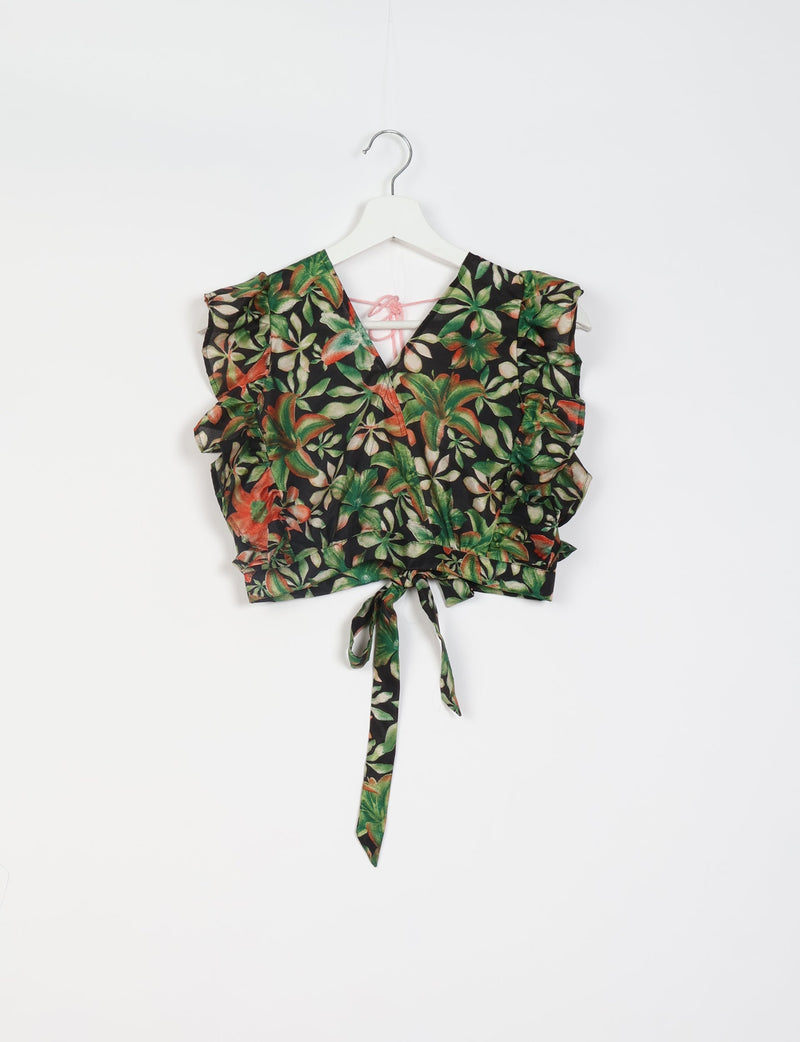 Black floral crop top with green and orange leaves, ruffled sleeves, V-neck, and tie detail at the waist, hanging on white hanger