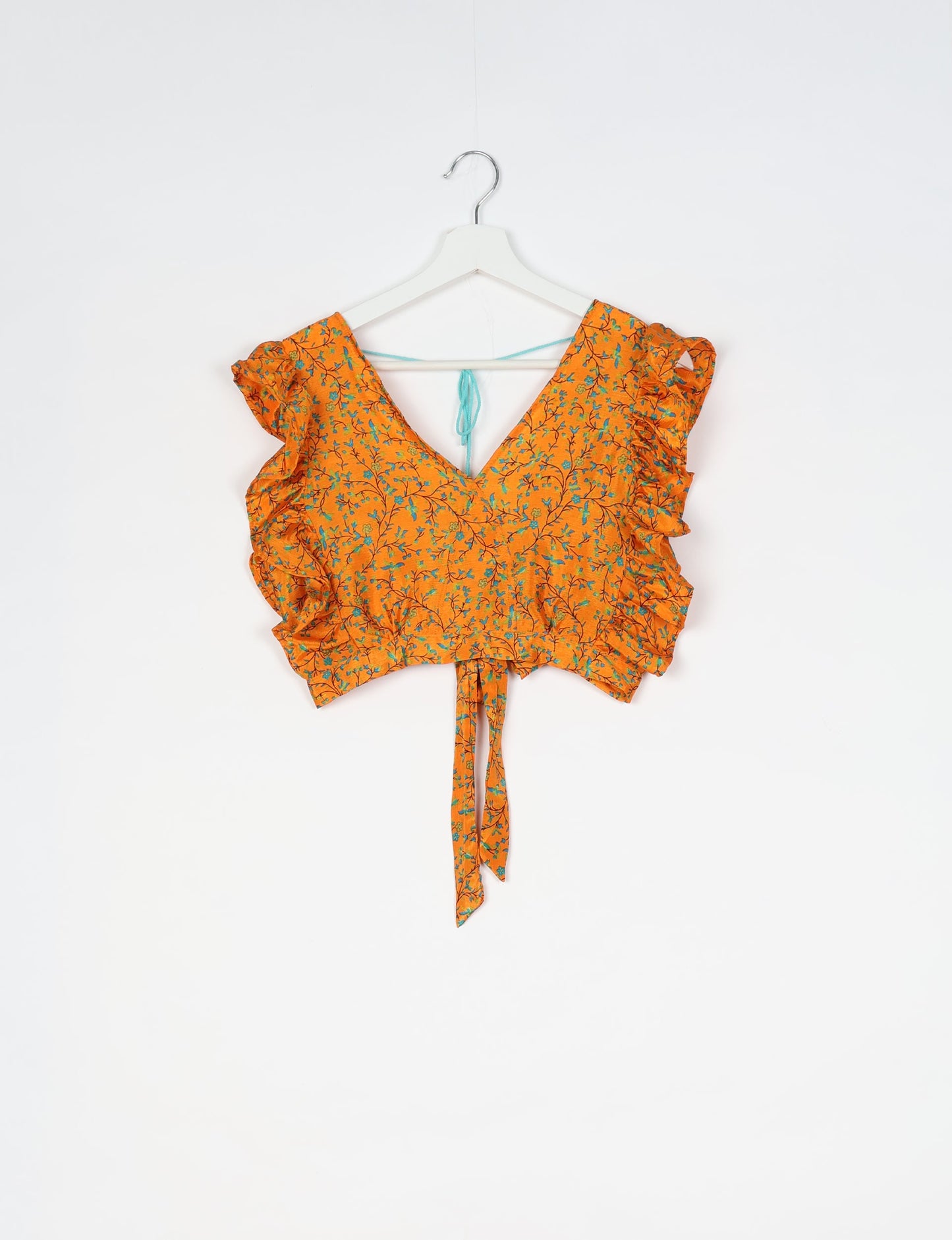 Frill Skirt Set made from recycled materials, highlighting sustainable fashion and fair trade practices. Features a ruffled wraparound skirt and a string-back top, symbolizing upcycled women's clothing and eco-friendly fashion.