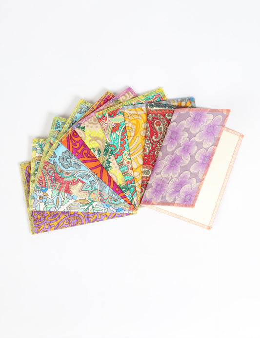 Sustainably crafted FOLDED POSTCARD SET, 10 assorted pieces made with 100% recycled paper and printed sari fabric sourced from Mumbai markets. Eco-friendly with contrast overlock edging. Envelopes included for eco-conscious gratitude and cheerful messages to loved ones.