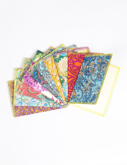 Sustainably crafted FOLDED POSTCARD SET, 10 assorted pieces made with 100% recycled paper and printed sari fabric sourced from Mumbai markets. Eco-friendly with contrast overlock edging. Envelopes included for eco-conscious gratitude and cheerful messages to loved ones.