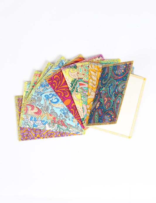 Sustainably crafted FOLDED POSTCARD SET, 10 assorted pieces made with 100% recycled paper and printed sari fabric sourced from Mumbai markets. Eco-friendly with contrast overlock edging. Envelopes included for eco-conscious gratitude and cheerful messages to loved ones.