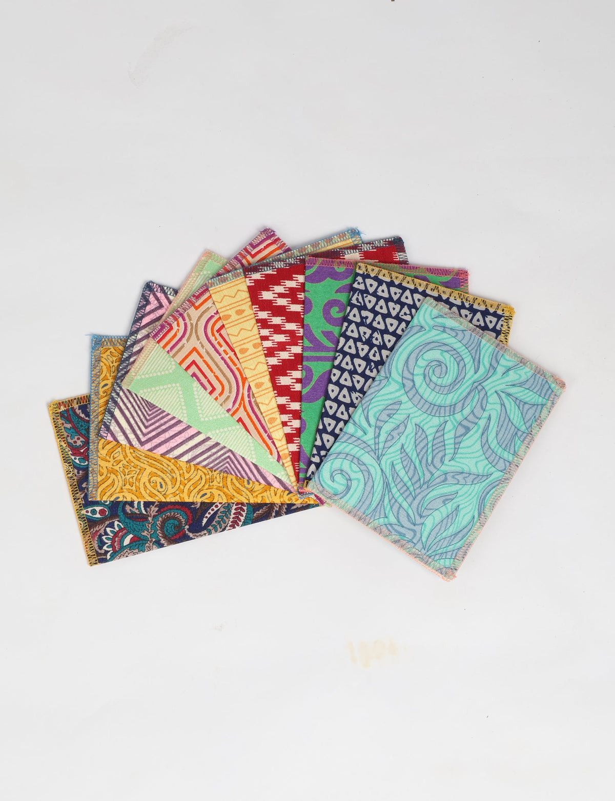 Set of 10 folded postcards with colorful geometric and floral patterns, shown fanned out on a white background