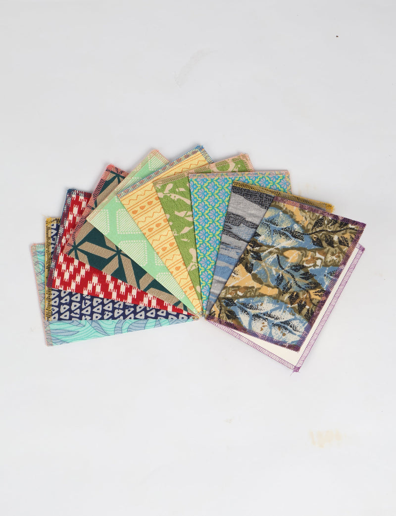 Set of ten folded postcards with colorful geometric, floral, and abstract patterns, shown fanned out on white background
