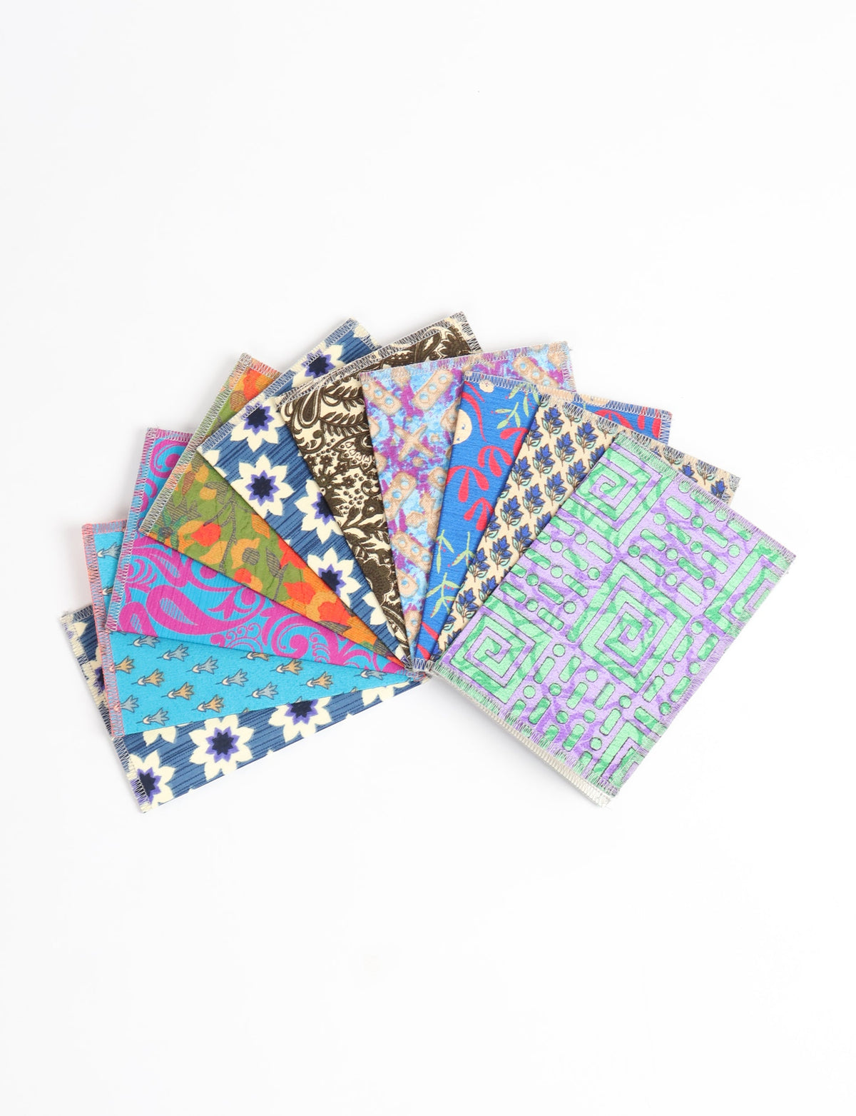 Set of 10 folded postcards with colorful floral, geometric, and abstract patterns, shown fanned out on white background
