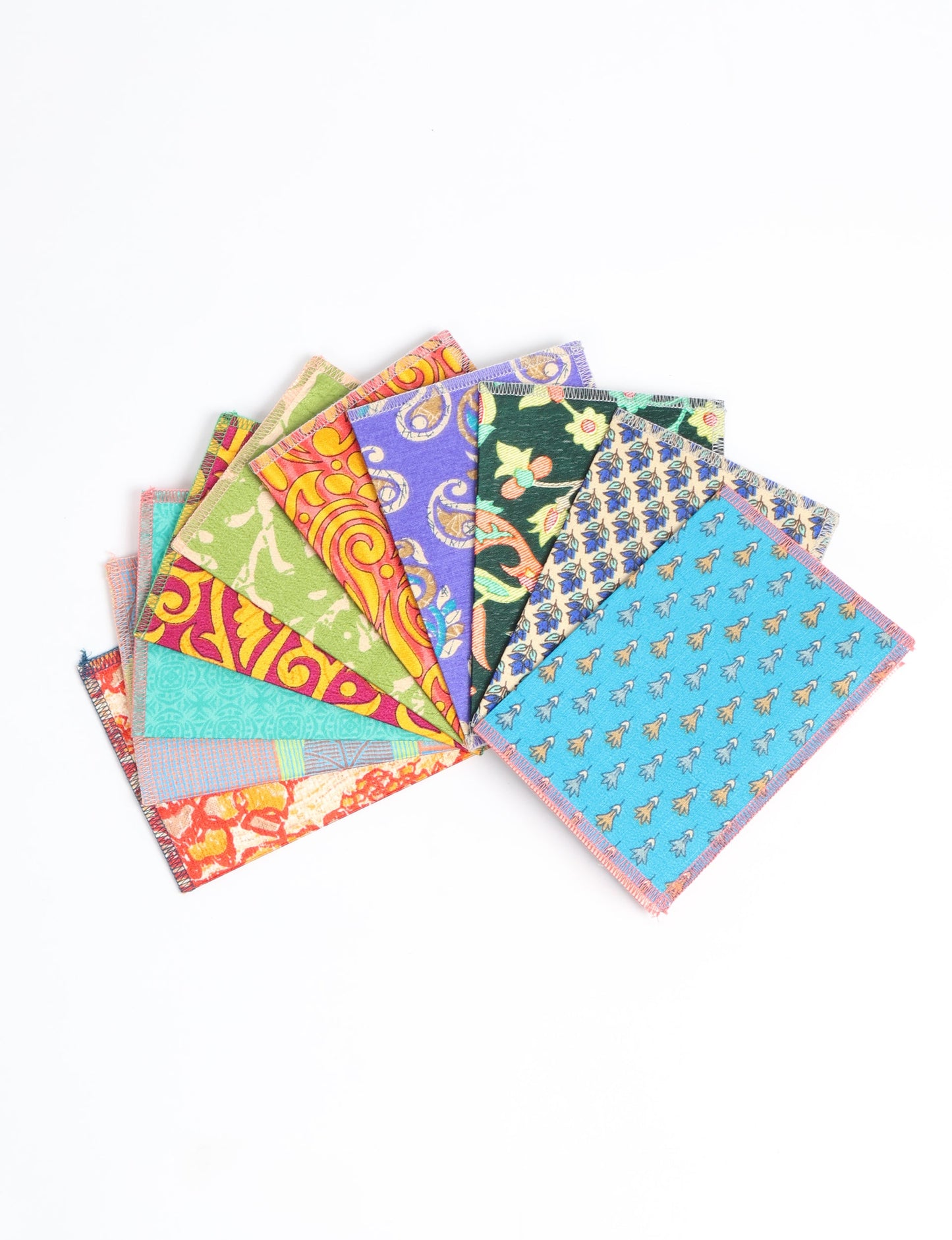Sustainably crafted FOLDED POSTCARD SET, 10 assorted pieces made with 100% recycled paper and printed sari fabric sourced from Mumbai markets. Eco-friendly with contrast overlock edging. Envelopes included for eco-conscious gratitude and cheerful messages to loved ones.