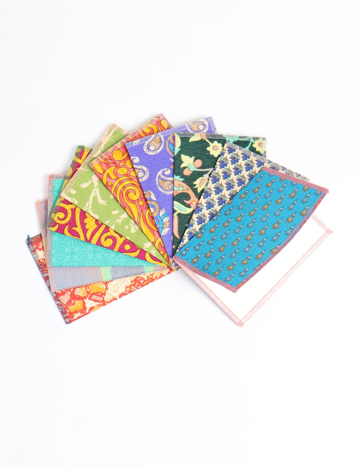 Sustainably crafted FOLDED POSTCARD SET, 10 assorted pieces made with 100% recycled paper and printed sari fabric sourced from Mumbai markets. Eco-friendly with contrast overlock edging. Envelopes included for eco-conscious gratitude and cheerful messages to loved ones.