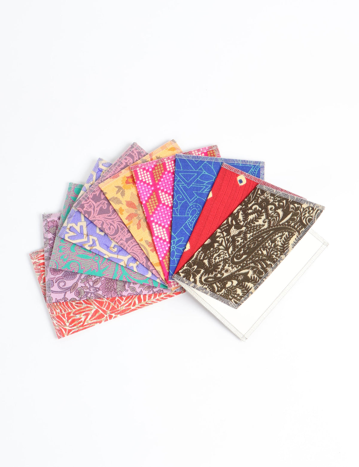 Set of ten folded postcards with colorful upcycled sari fabric covers in various patterns, fanned out on white background