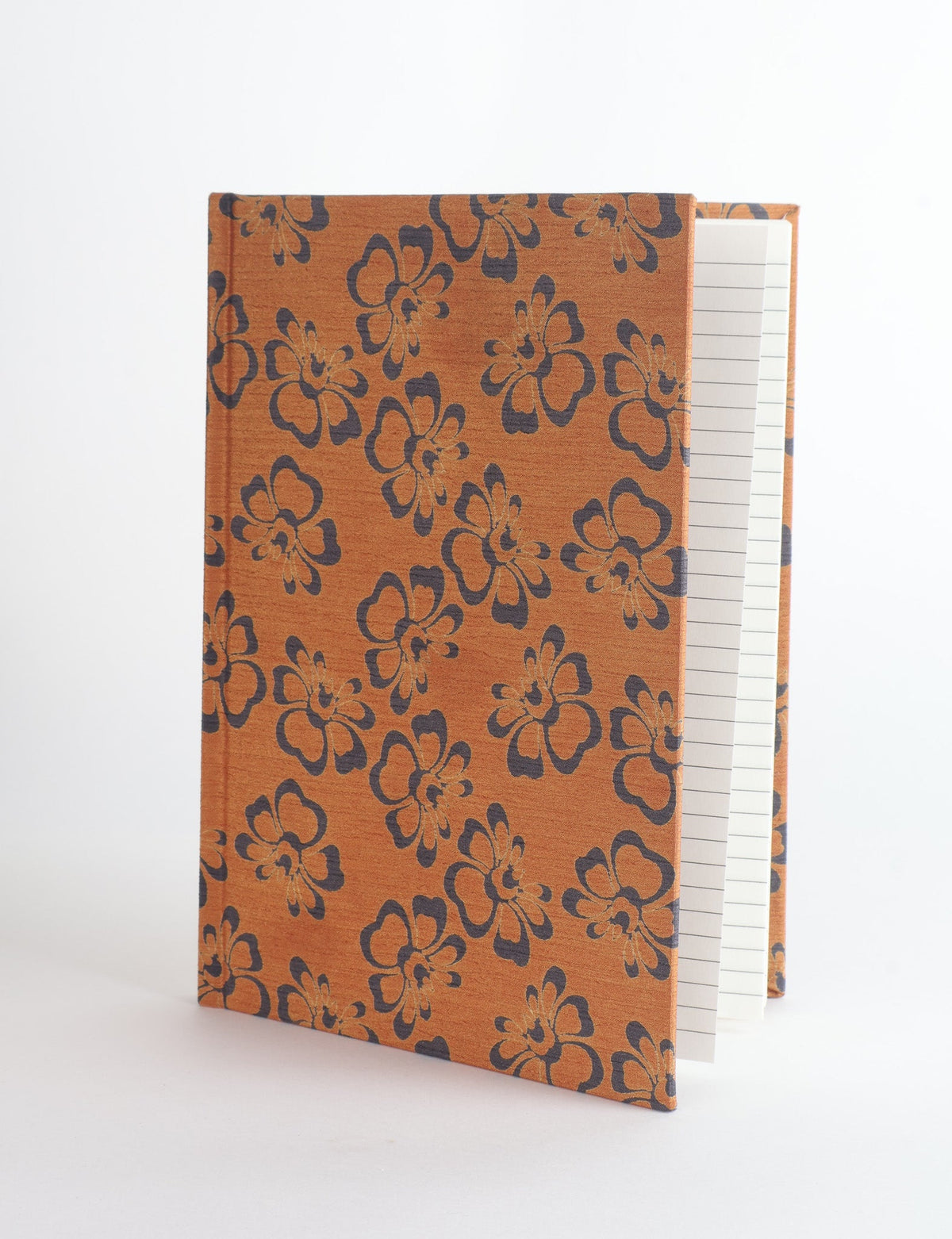 A5 hard cover notebook with orange floral pattern, partially open showing lined pages, front angled view